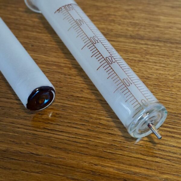 vintage syringe in glass