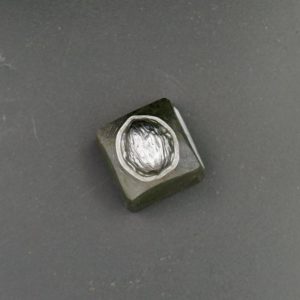 Steel paperweight with an engraved nut
