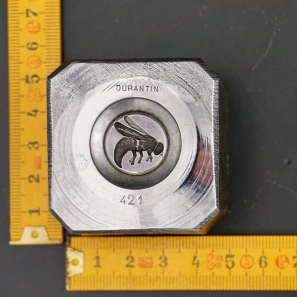 Fly engraved in a steel block