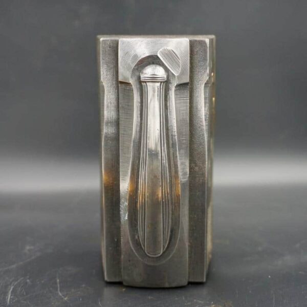 Knife handle engraved in a block of steel