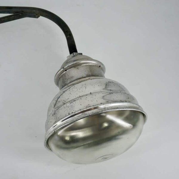 Lamp with galvanized arm for outdoor use.